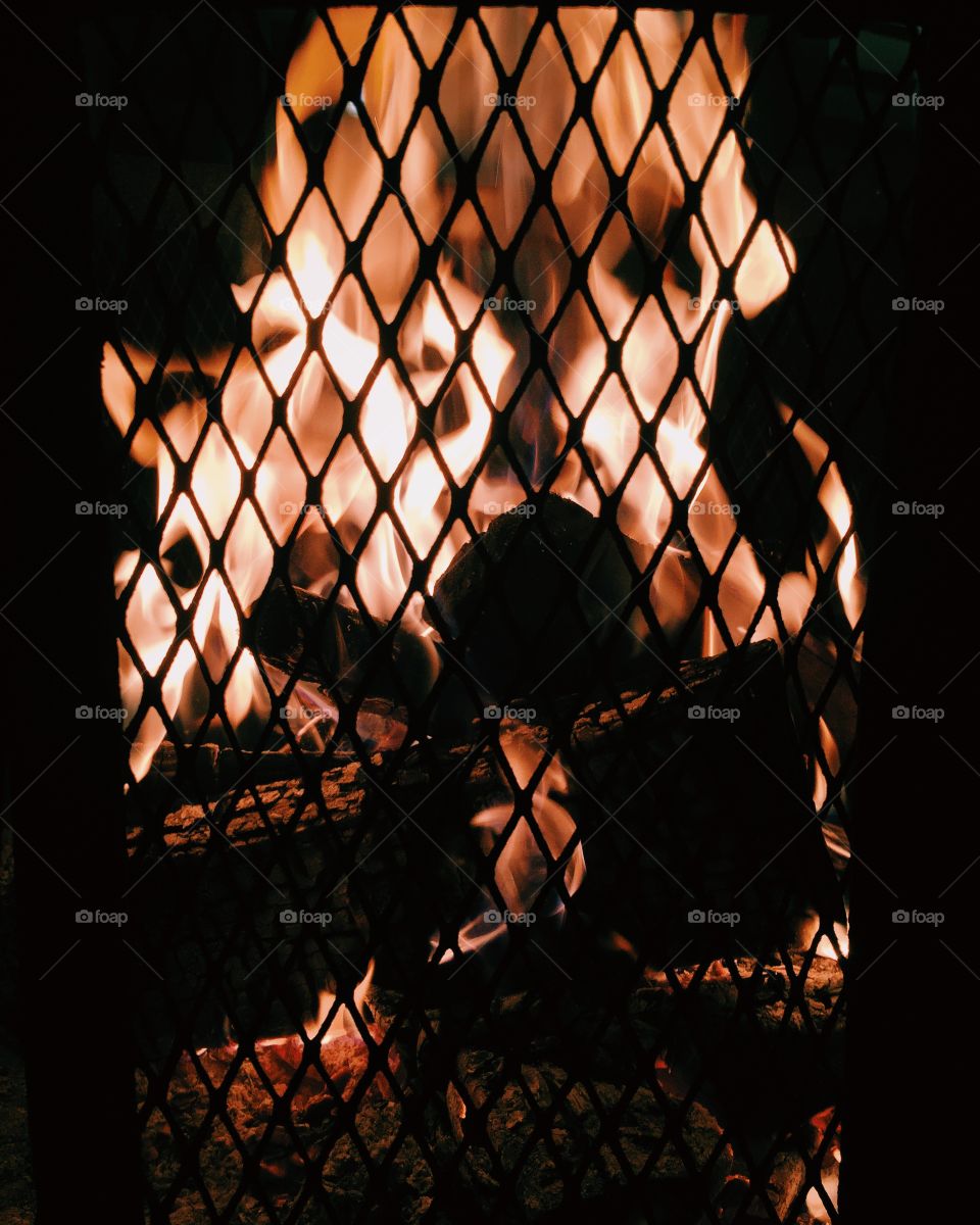 Fire behind metal grate 