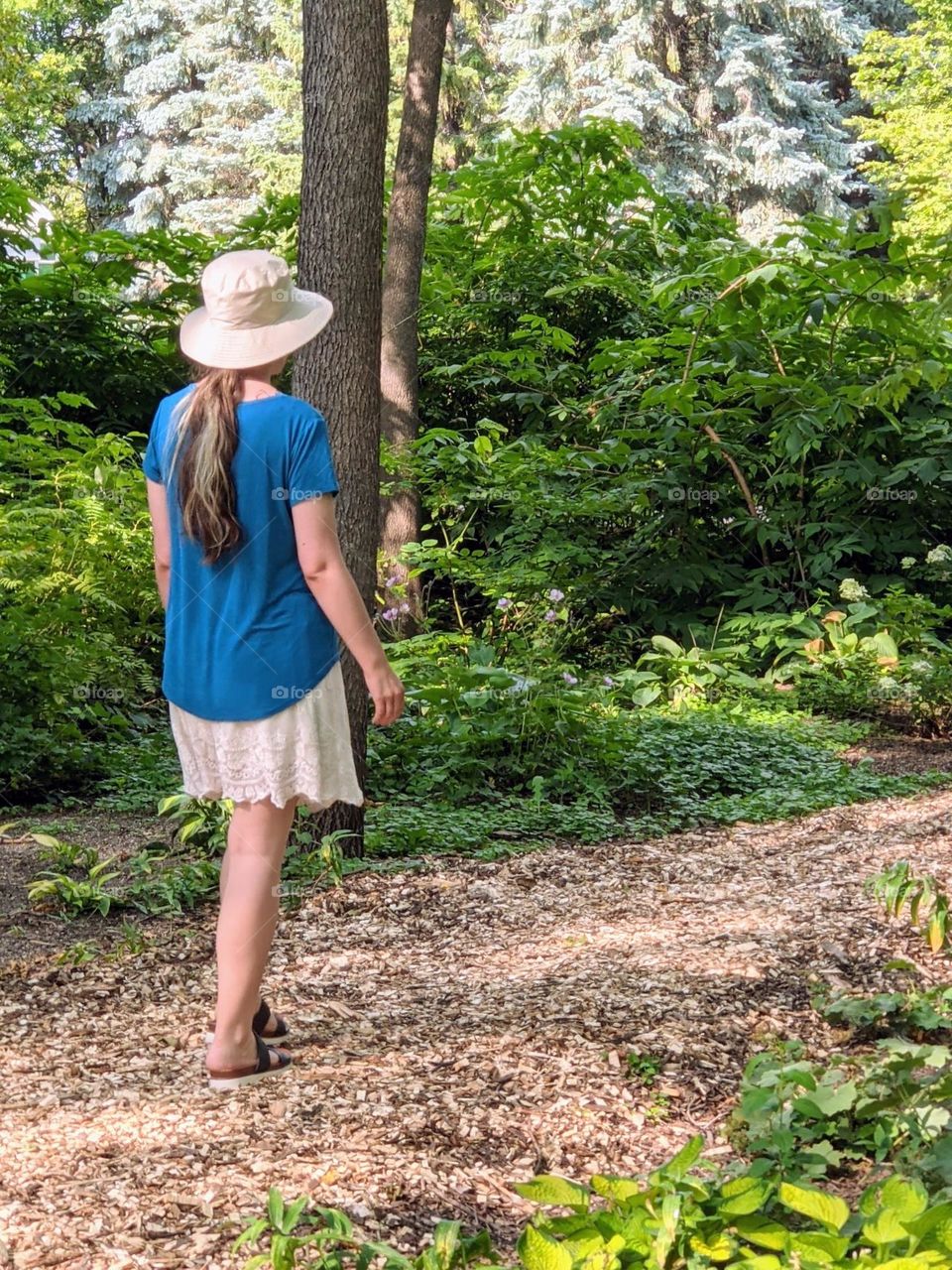 girl in blue walking in the park