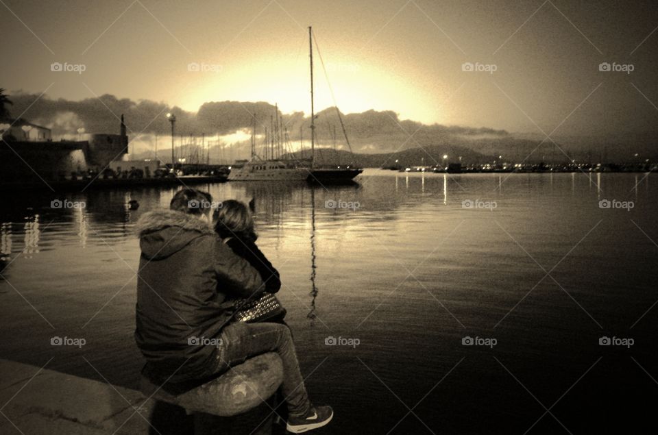 lovers in front of sea At sunset