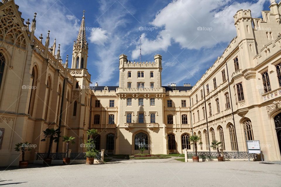 Lednice Chateau with beautiful gardens and parks on sunny summer day. Lednice-Valtice Landscape, South Moravian region. UNESCO World Heritage Site.