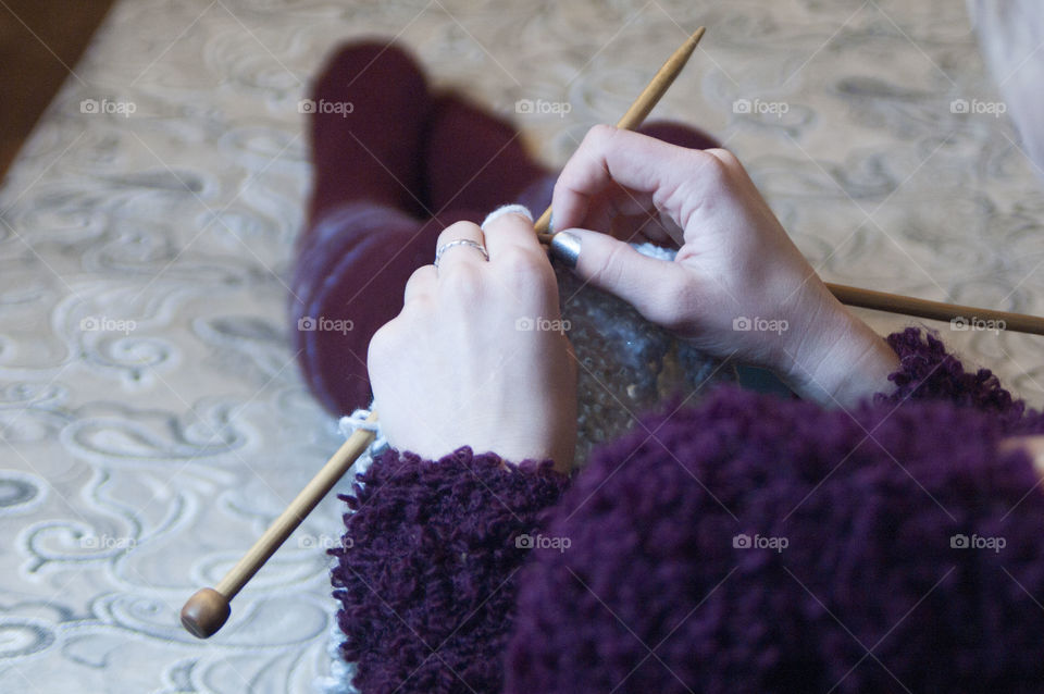 A woman holding a knitting needle