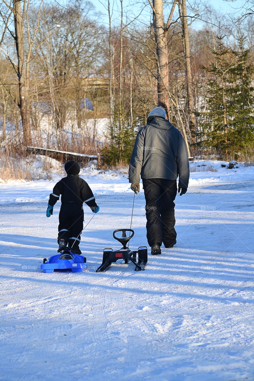 Father and son with their sleds