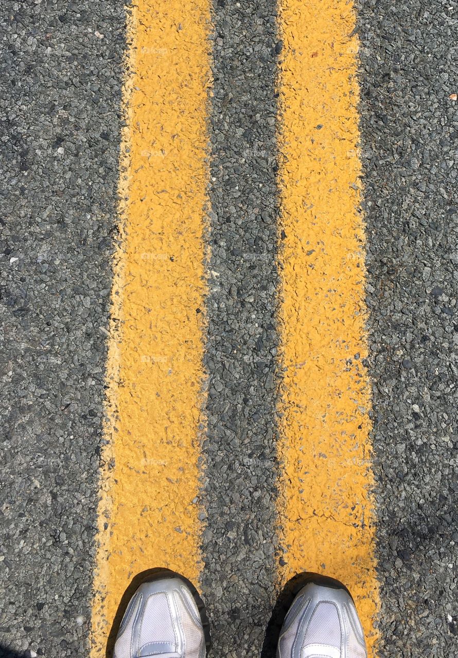 Two yellow lines down the middle of the road.
