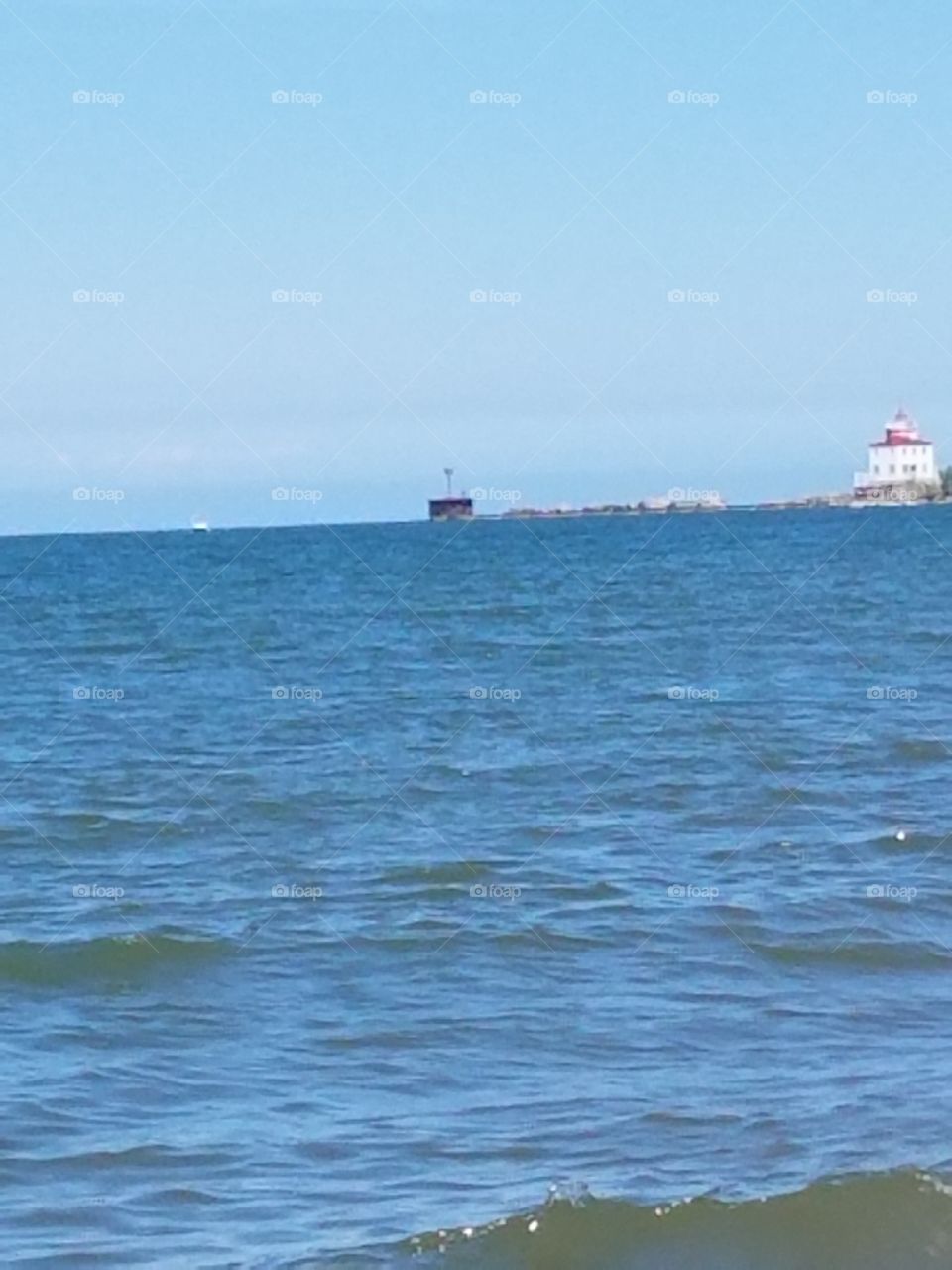 beach water, lighthouse from a distance