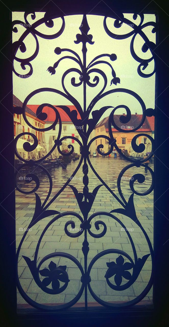 The view on the city square through baroque doors