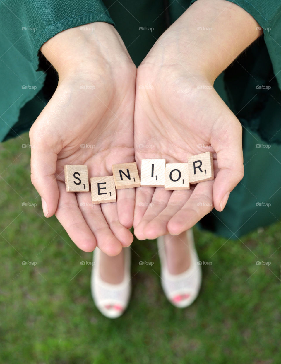 Senior!. Senior spelled out in scrabble tiles in someone's hand 