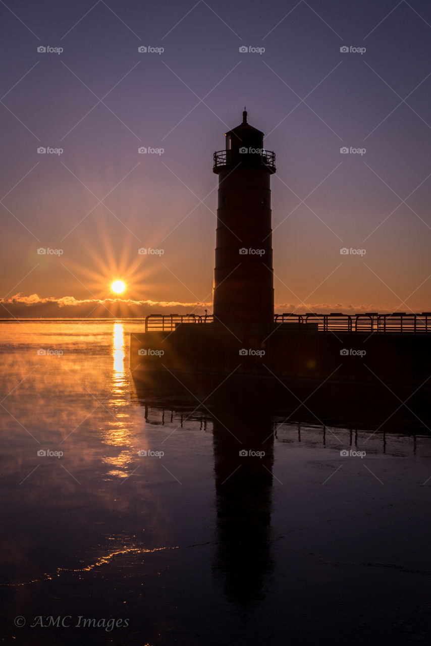 Sunrise photo of a red light house in Milwaukee Wisconsin on Lake Michigan