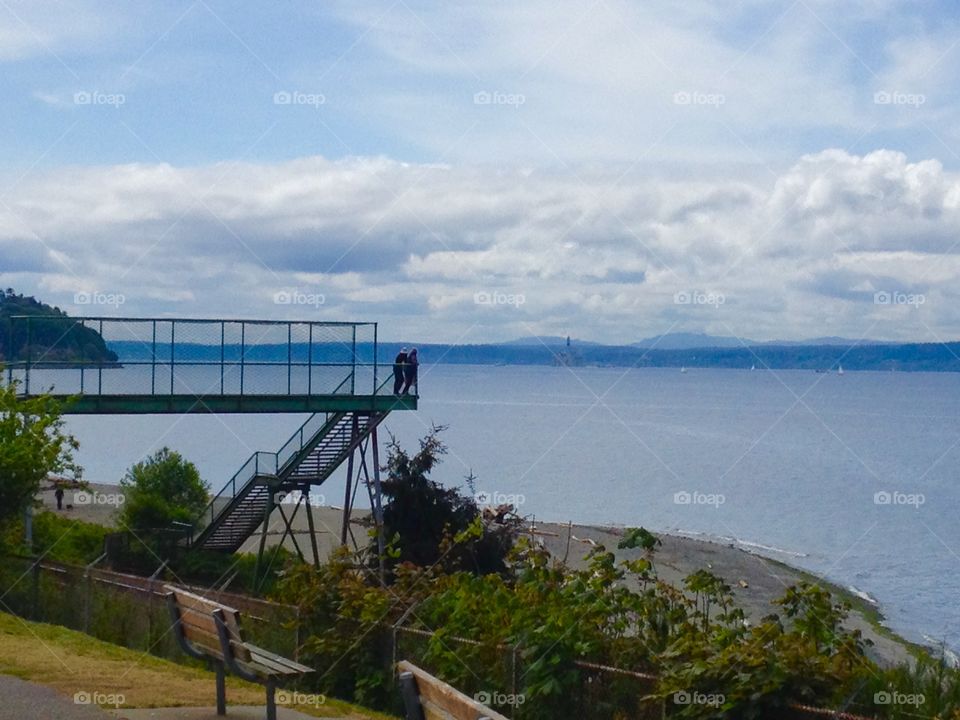 Look out. Two people admire the view from the bridge 
