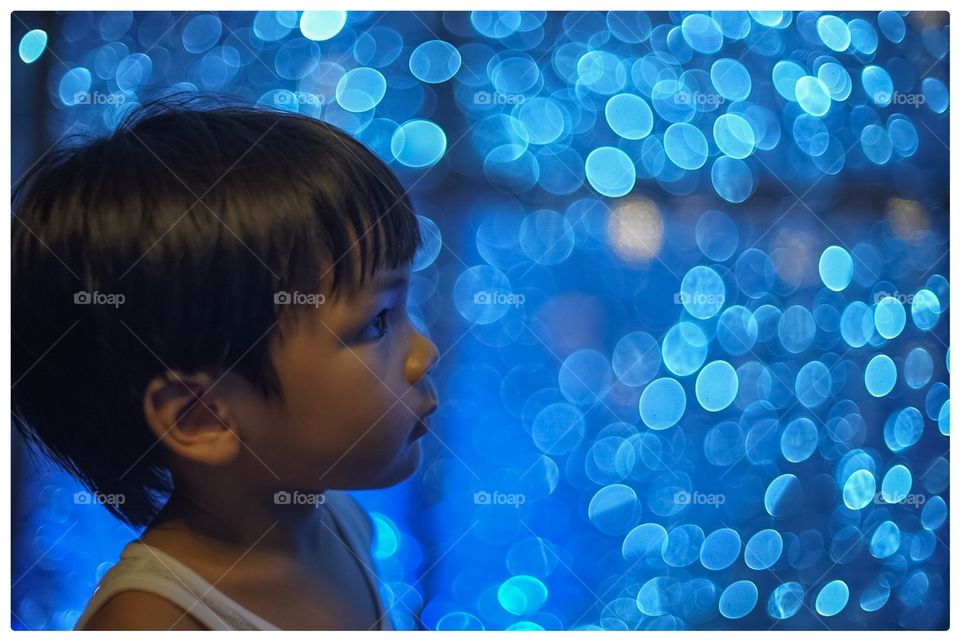 Asian boy on blue bokeh background