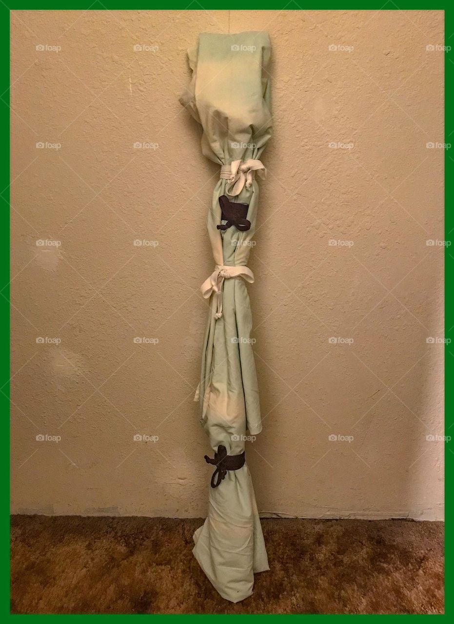 A sheathed, battle-ready M1860 light cavalry saber wrapped in a cloth for concealment.