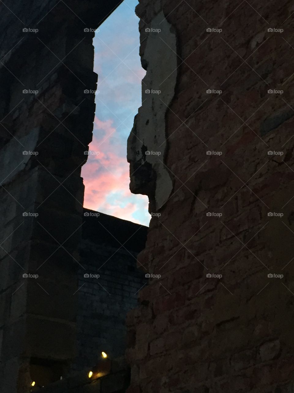 Sunset through crack of a wall