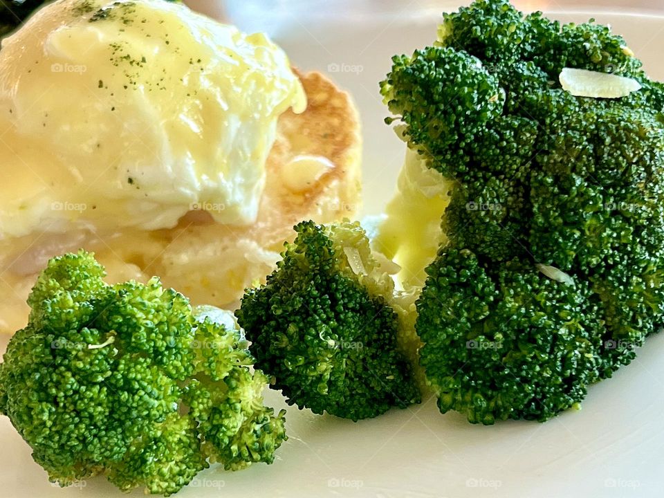Healthy and tasty breakfast. Eggs Benedict and broccoli