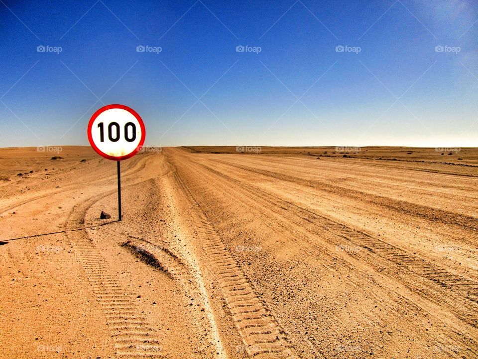 Speed limit sign on a gravel road