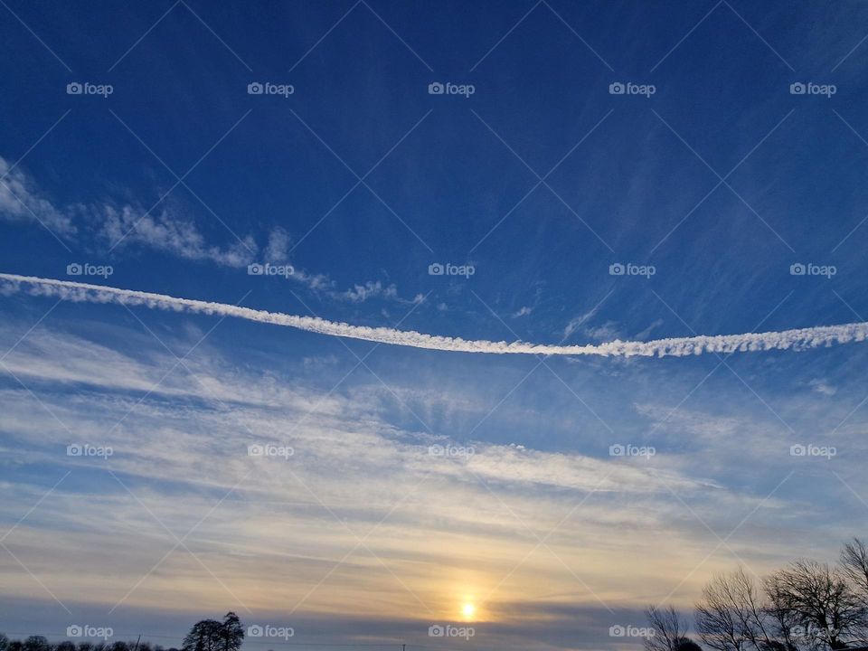 Vapor trail at sunrise