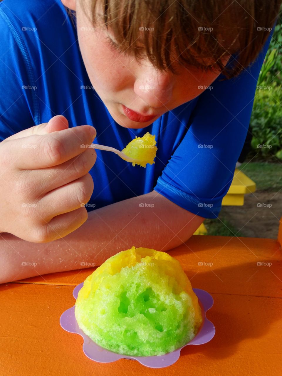 Boy Eating Colorful Hawaiian Shave Ice Treat