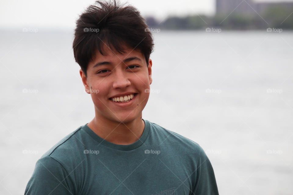 Handsome young man laughing outdoors