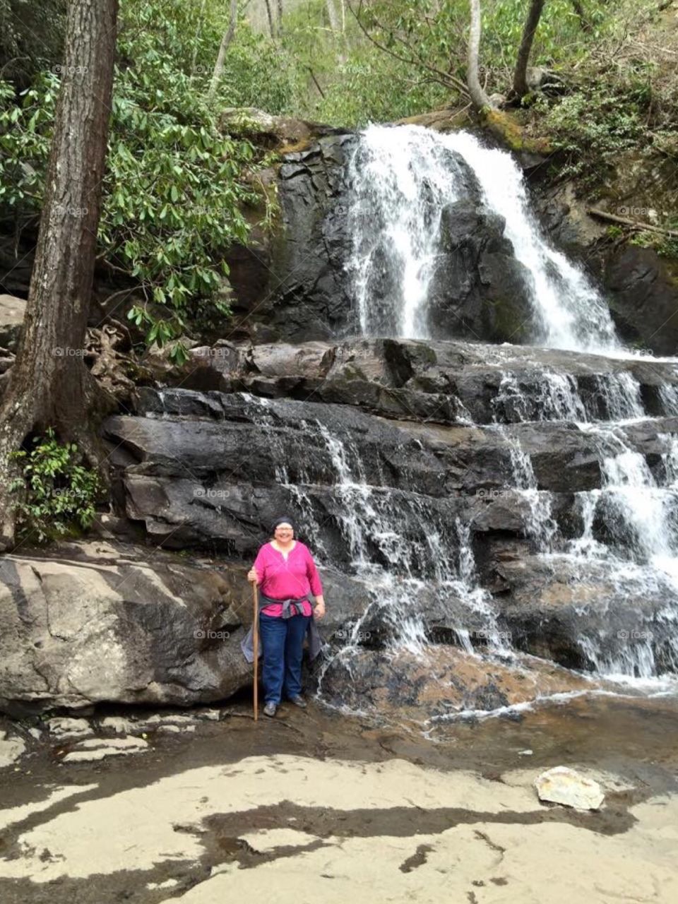 Cancer survivor : Ovarian cancer survivor celebrating remission in Tennessee hiking in mountains to waterfall.