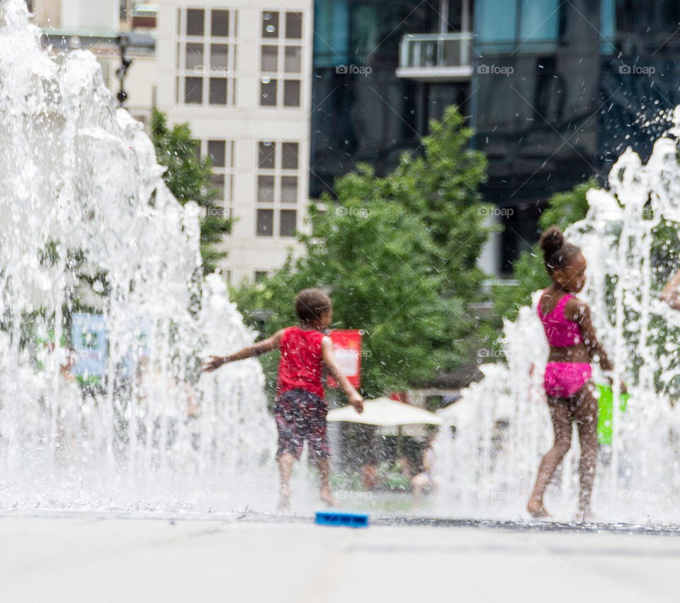 Photo of kids cooling off on a hot summer day