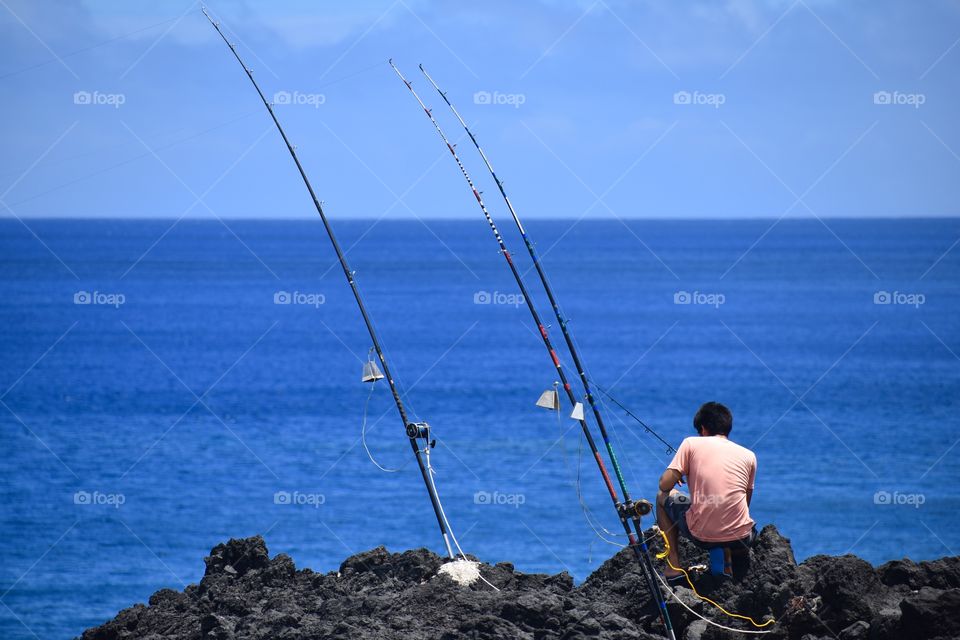 Fishing off the sea cliffs on the east side of the Big Island of Hawaii - with bells on.