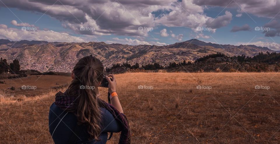 Rear view of women holding camera