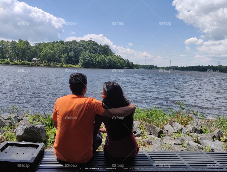 Love
Internal peace love birds sitting on the bench in front of beautiful lake view