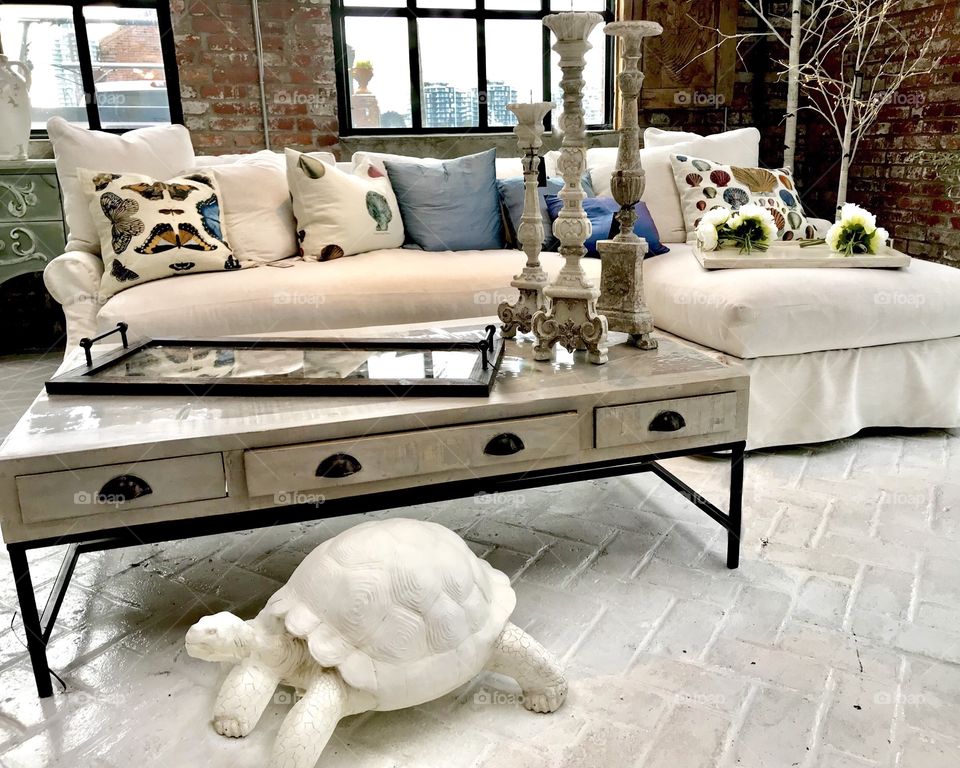 Modern living room with white sofa and turtle statue 