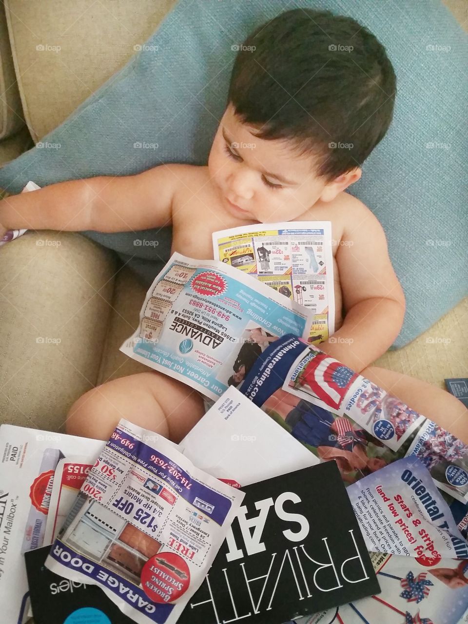 Small kid sitting with paper