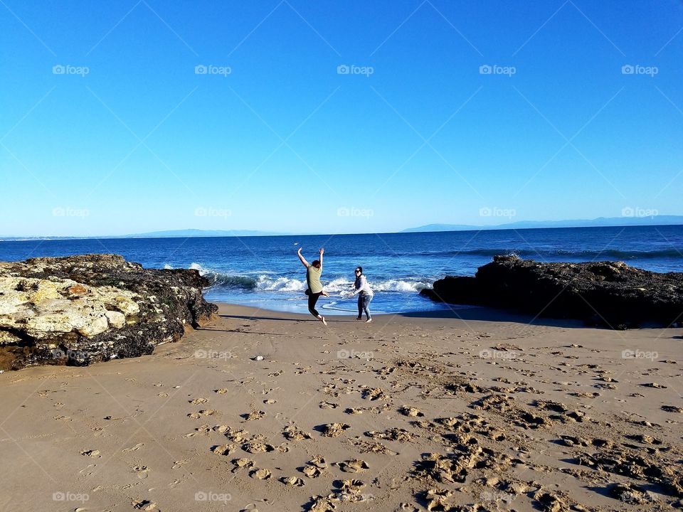 Best friends playing by the sea