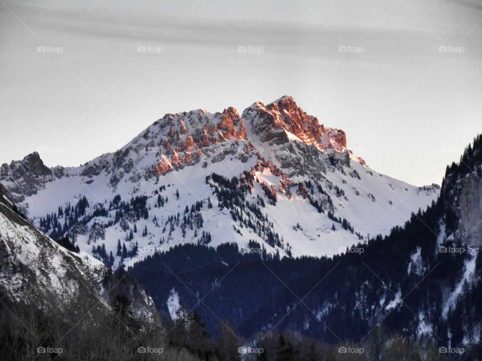 coucher de soleil sur une montagne enneigée