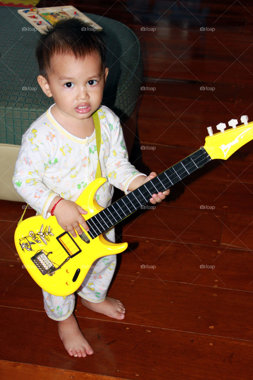 A rocker is born. Thithi at the guitar