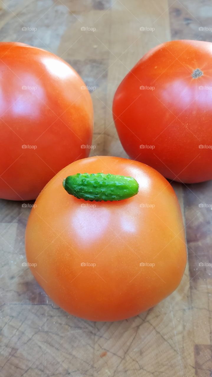 Giant tomatoes OR Teeny Tiny cucumber, homegrown harvest.