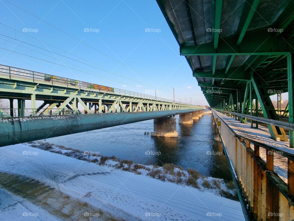 Lines: view from inbetween steel bridges over the Vistula River in Warsaw, Poland