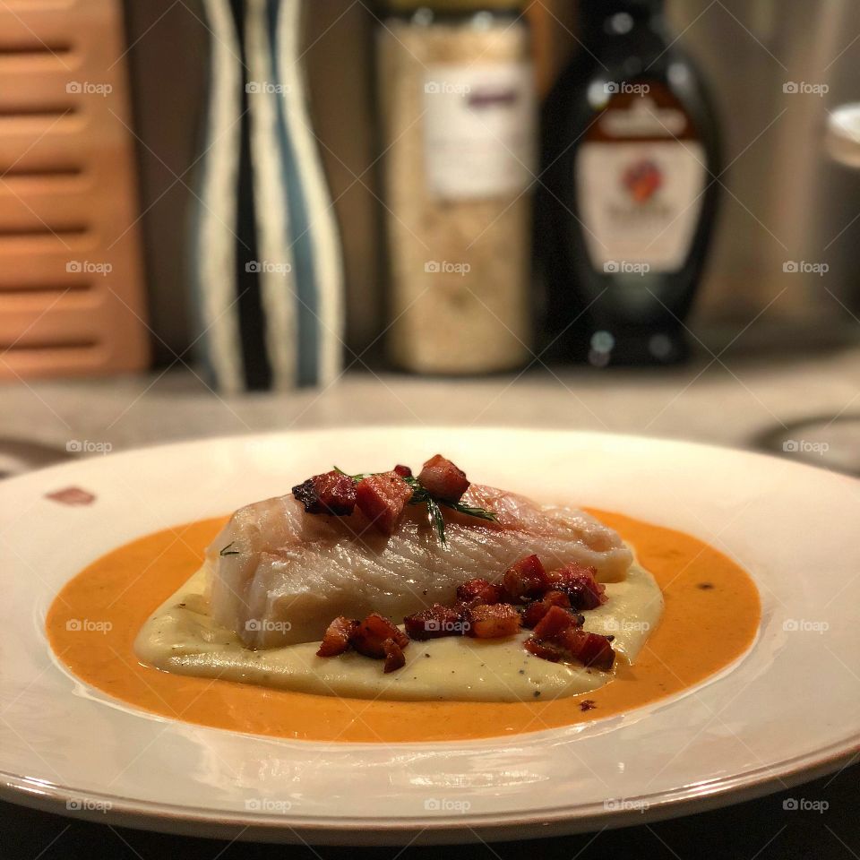 Amazing sous vided cod with lobster sauce, crispy pancetta bits, and celeriac puree