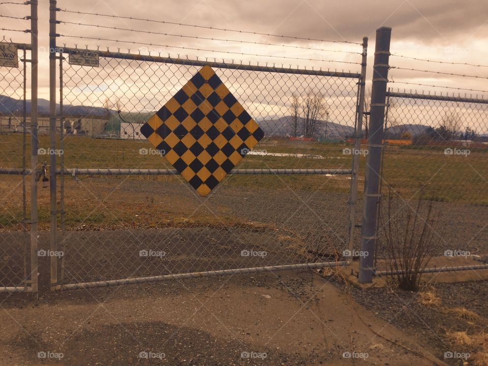 Yield Sign in Front of the Gate