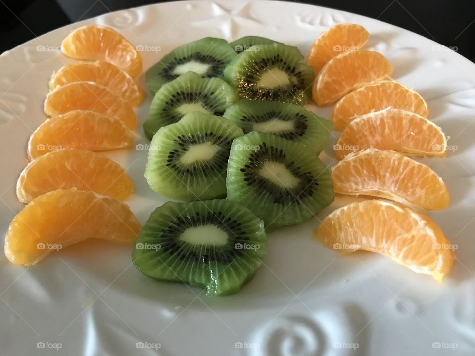 Kiwi and mandarin slices on a plate