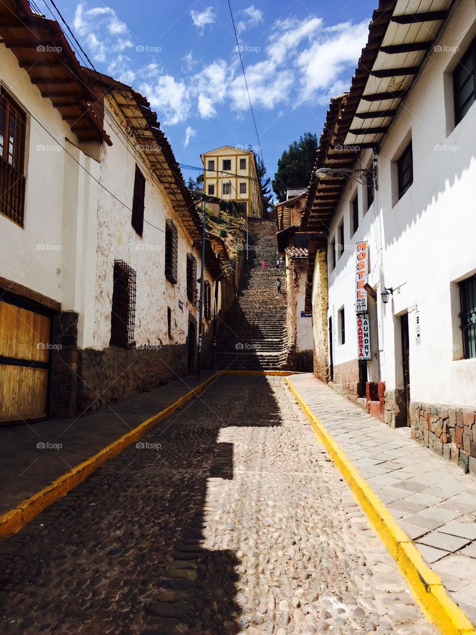 A quiet side street in Cusco leads to a steep stairway. 