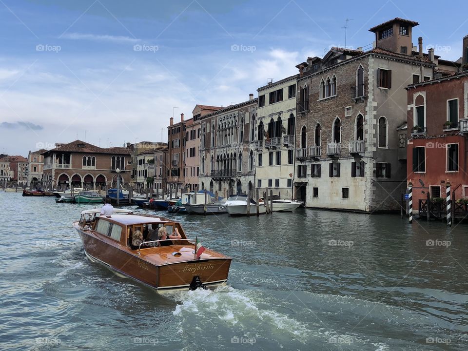 Fine wood boat motors through Venice, Italy.