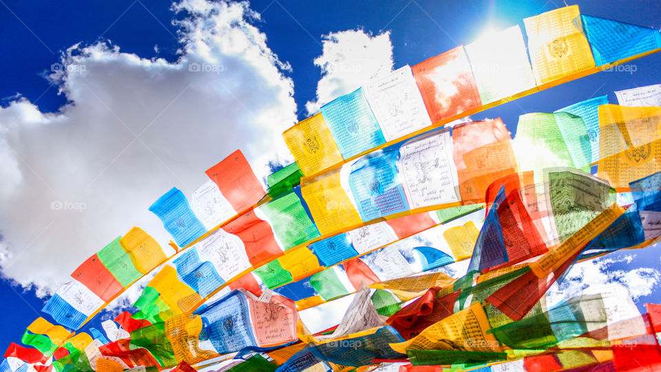 Five-colored prayer flags under the blue sky
