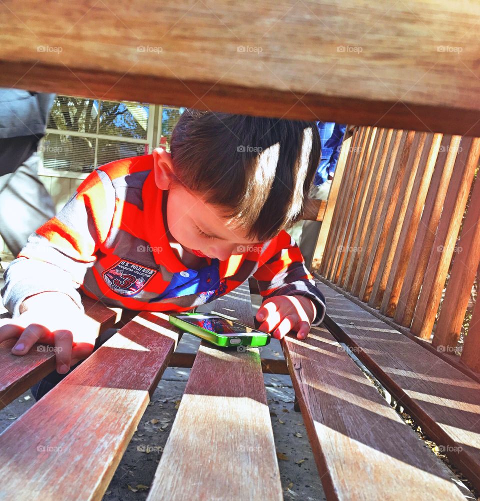 Close-up of a boy looking in cellphone