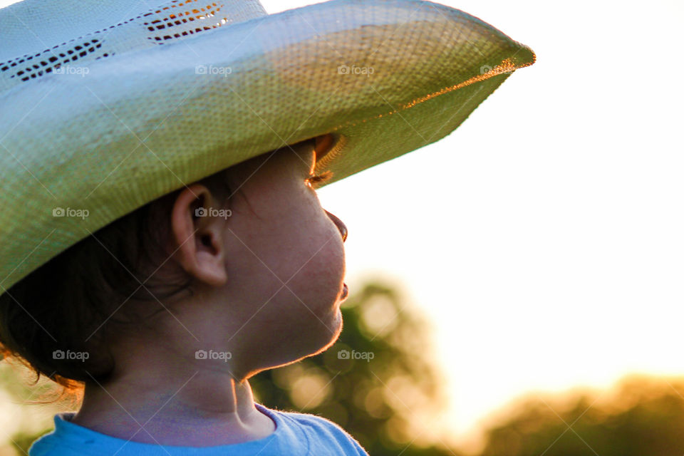 Side view of boy with hat