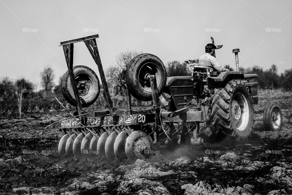 man work on filed with tractor