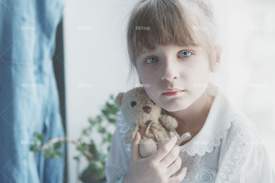 Little girl with her teddy