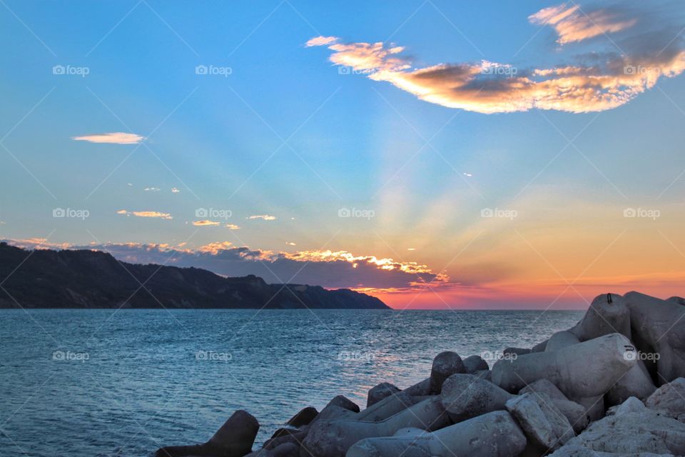 Sun rays at sunset over the sea