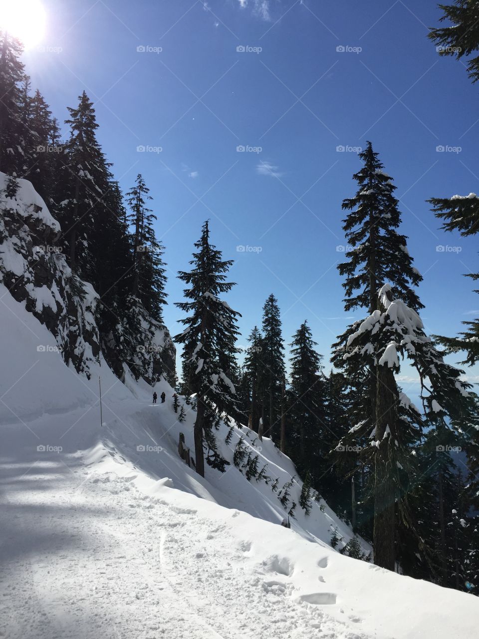 Snowshoeing on grouse mountain on a sunny winter day in British Columbia 