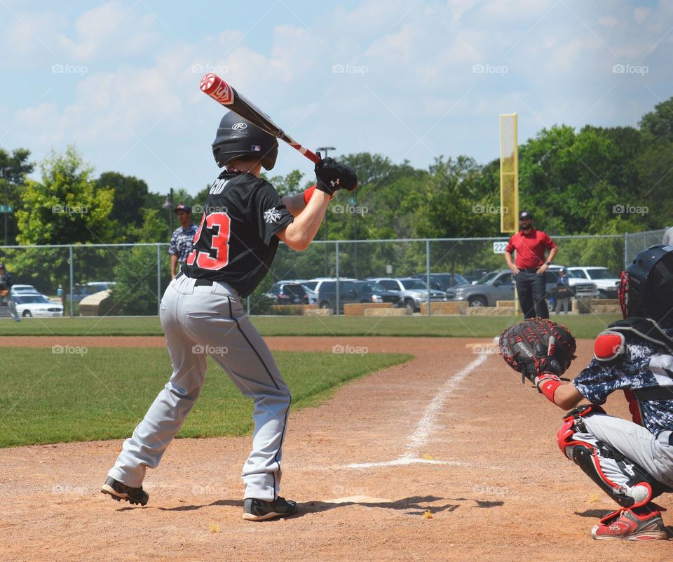 Youth baseball player at bat. 