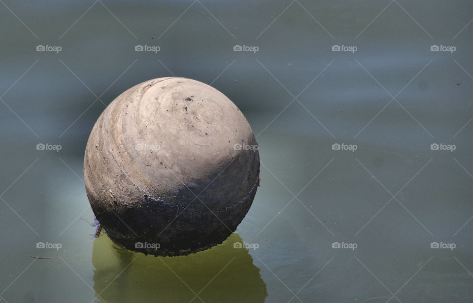 A buoy in the polluted Gowanas Canal, Brooklyn, New York City.