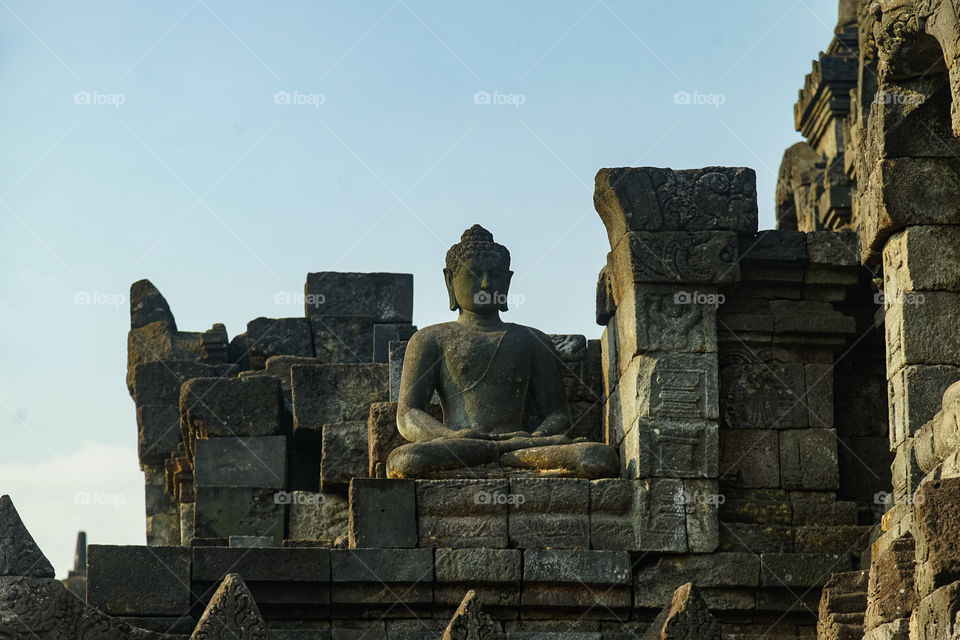 one of buddha statues in borobudur temple, facing the ground