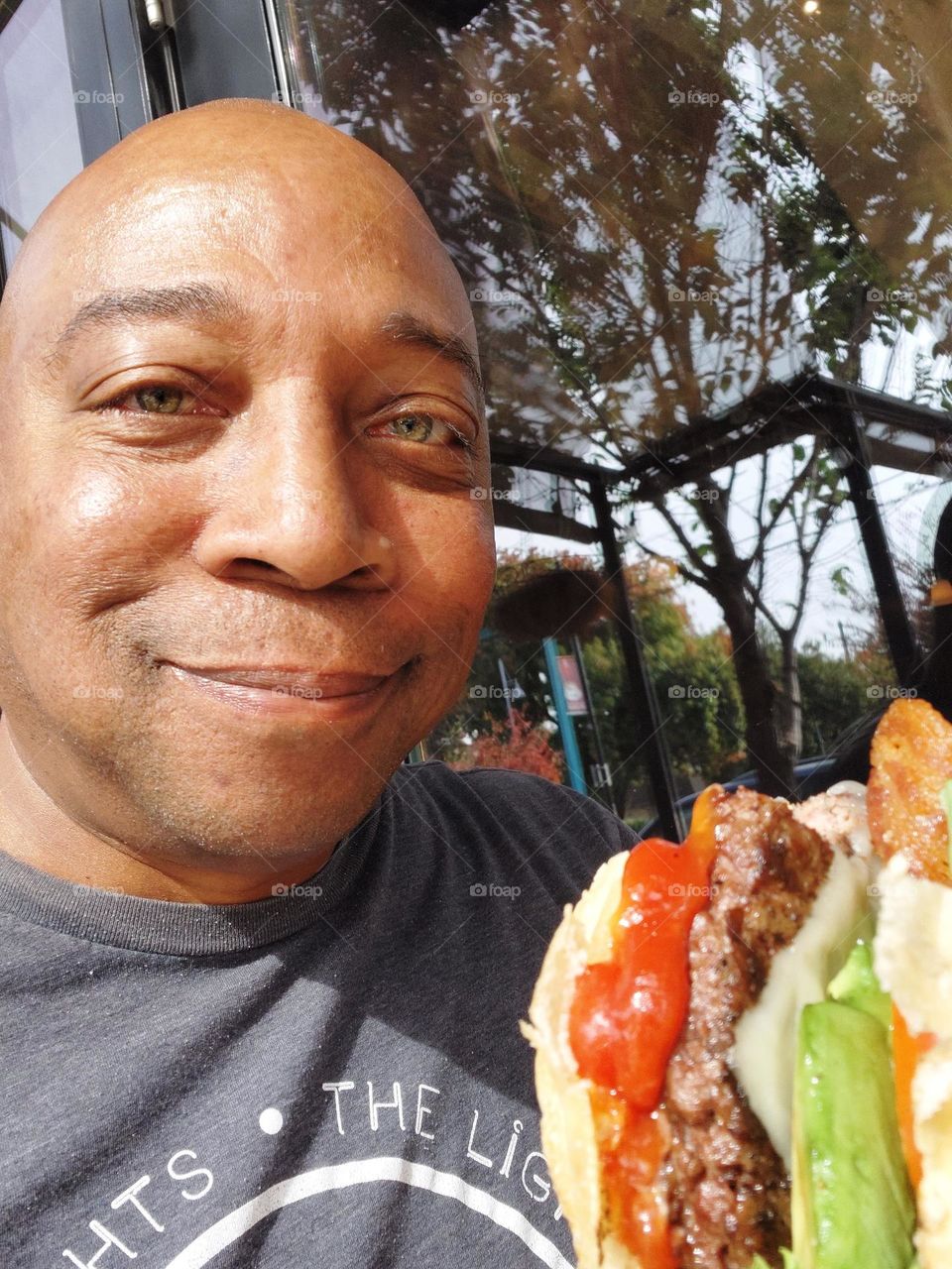 selfie pic avocado bacon burger with onions tomatoes and lettuce eating good in the neighborhood