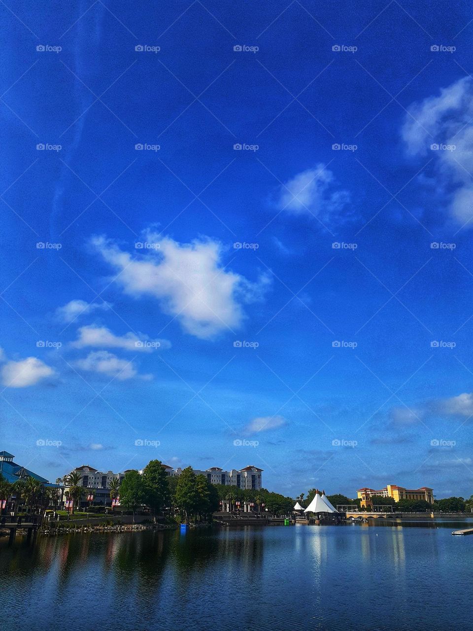 A beautiful landscape photo featuring a beautiful blue sky and lake at Cranes Roost Park in Altamonte Springs, Florida.