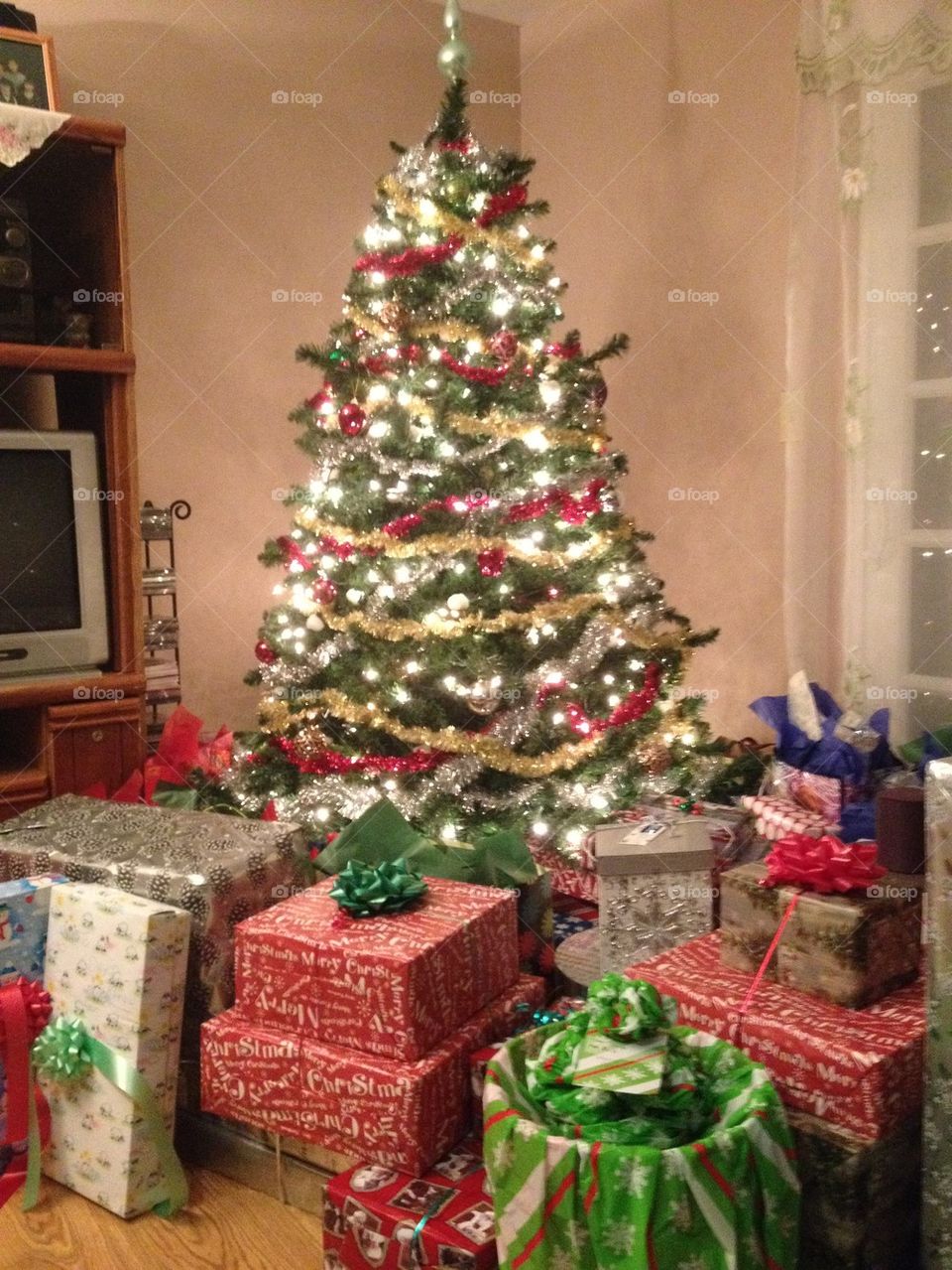 Celebrating Christmas at parents home with whole family.. Our Christmas tree with presents. 